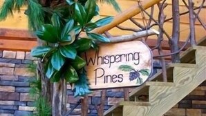 A wooden staircase with a sign that reads "Whispering Pines." - Luxury Lake Chalet Hot Tub Private Boat Slip  Amazing Mountain View’s Sleeps 10 (Butler)
