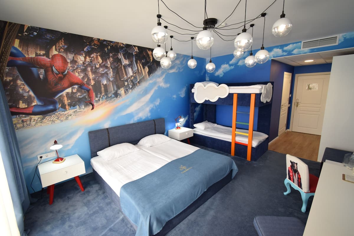A bedroom with a bed, a nightstand, a dresser, a bunk bed, and a chair.