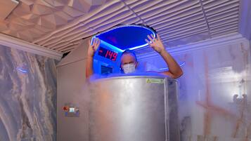 A person inside a metallic elevator with a digital display showing "-149".