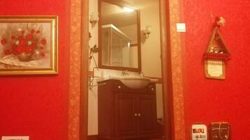 A staircase leading to a bathroom with a sink and mirror.