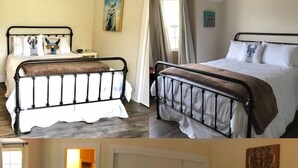 A bedroom with a bed, a bedside table, a mirror, and a door. - Alpaca Suite at Rellik House. Winery & Alpaca Farm (Central Point)
