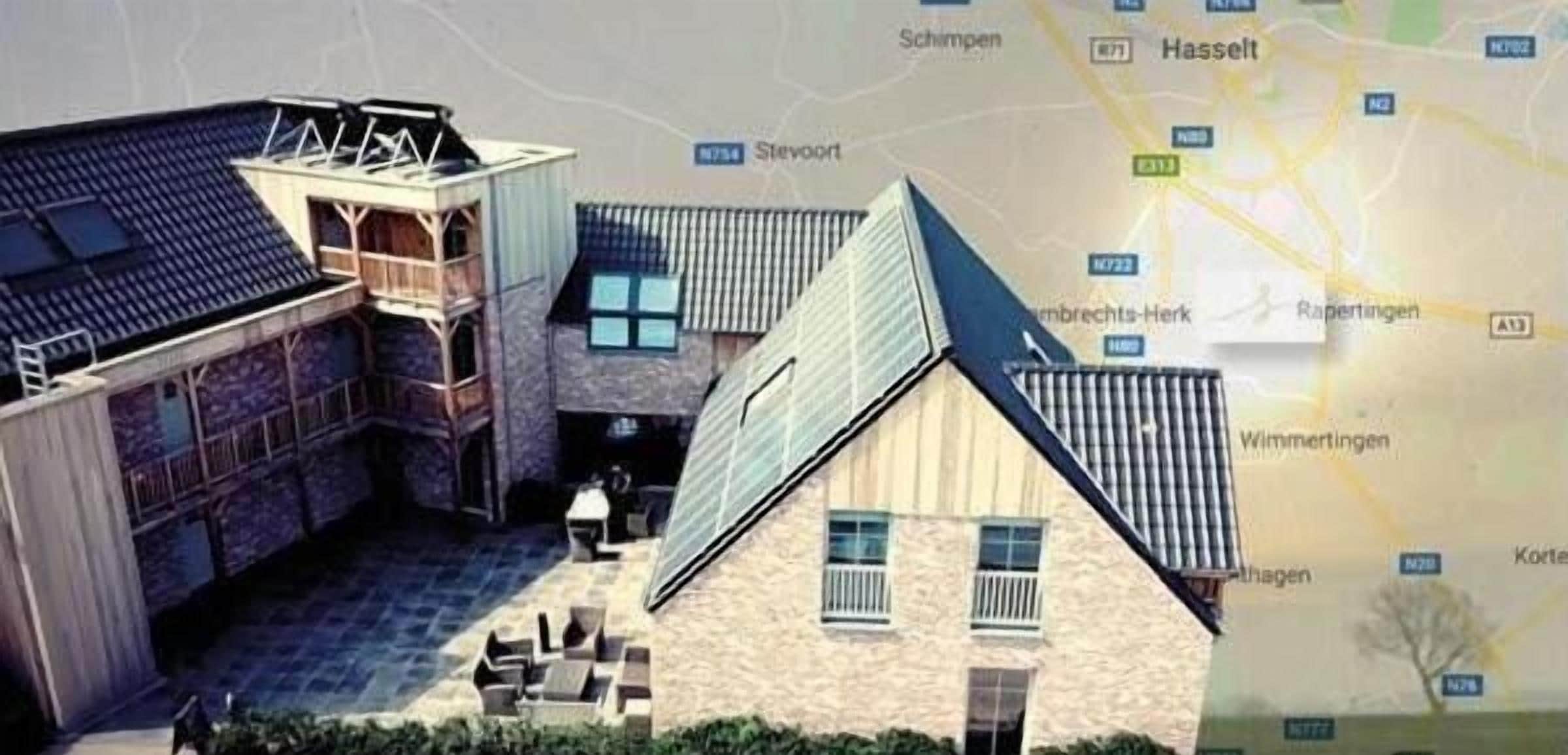 A model of a building with a courtyard, a covered area, and a traditional house with a sloped roof.