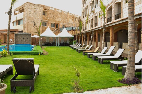 Indoor pool, outdoor pool, pool umbrellas, pool loungers