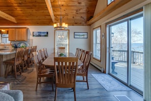 Enjoy family meals and gatherings in this spacious dining area with a long table and matching chairs.