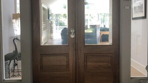 A double wooden door with a glass panel, a welcome mat, and a number '3' sign on the wall. - Sea Pines Home with Sparkling Heated Pool-Hole #2 Harbour Town Golf Links-Grill (Hilton Head Island)