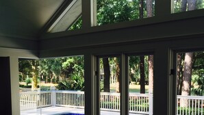A view of a swimming pool with a white fence and trees in the background. - Sea Pines Home with Sparkling Heated Pool-Hole #2 Harbour Town Golf Links-Grill (Hilton Head Island)