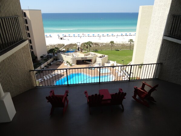 A balcony with a pool, lounge chairs, and a view of the beach and ocean. - LOCATED DIRECTLY ON THE BEACH! Top of the Gulf 322 ...DISCOUNTED RATES (Panama City)