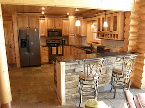Enjoy cooking in this well-equipped kitchen with a central island and bar stools.