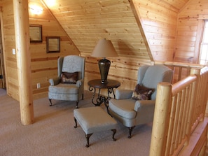 Relax in this inviting space with plush armchairs, a cozy reading nook, and a comfortable bench.