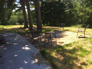 Sit and unwind in a serene outdoor space surrounded by lush trees and greenery.