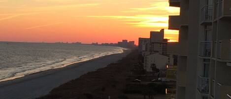 A coastal view with a beach and buildings.