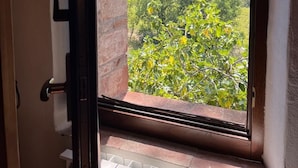 A doorway with a view of a lush green landscape and hills in the distance.