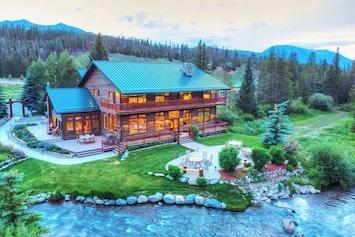 A view of the back lawn, patio and river