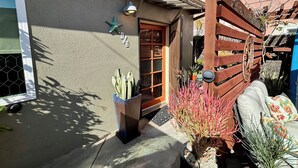 A residential house with a wooden door, a starfish decoration, and a potted plant. - 🌊🌊 2026 @ the Starfish Cottage. Steps to Ocean. RELAX & ENJOY  the beach. 🏖️ 😎🏖️ (seal beach)