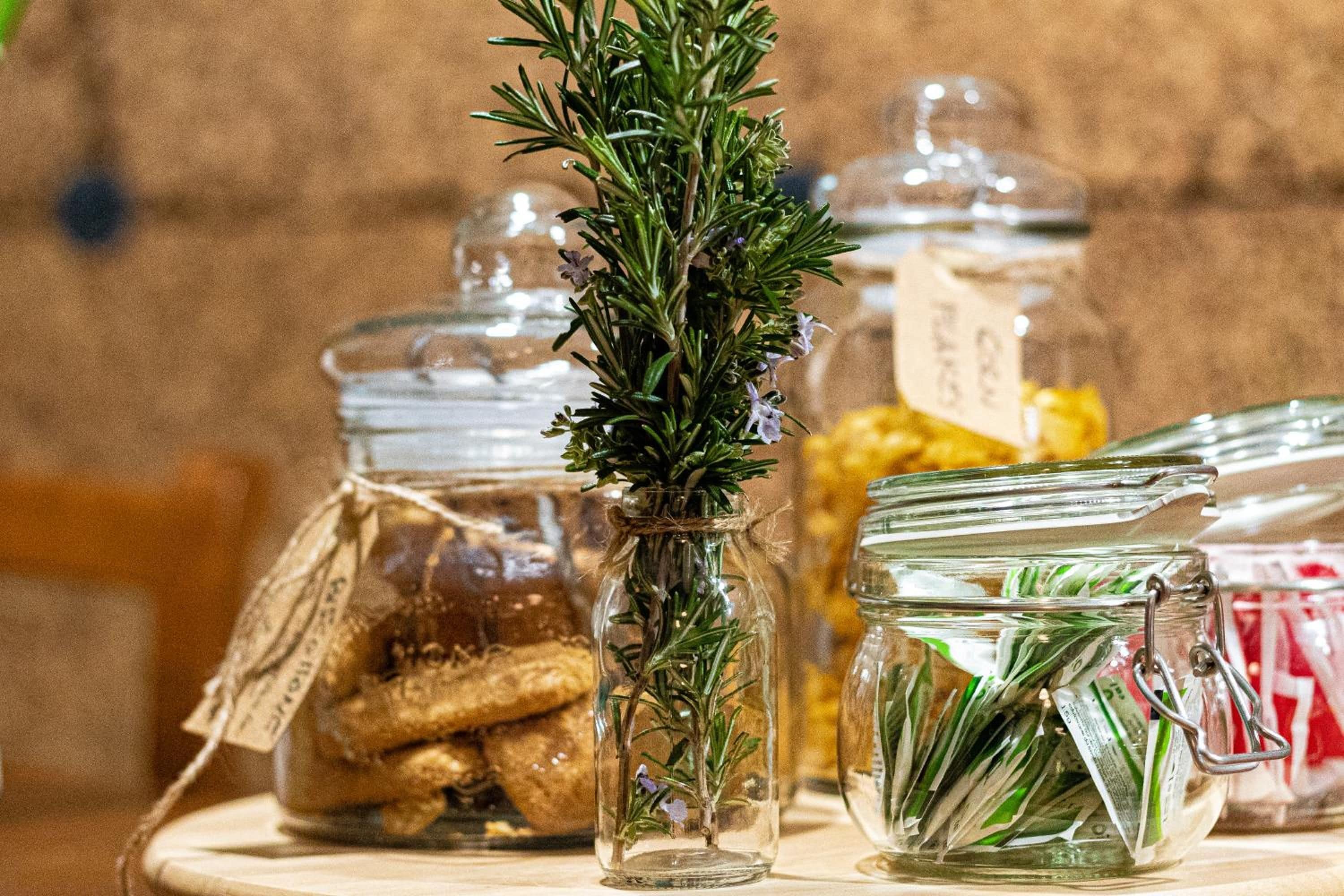 A table with glass jars containing various food items.