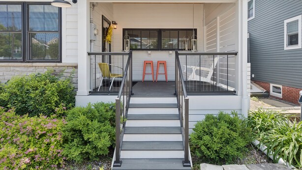 A modern house with a covered porch, a staircase, and outdoor seating. - 100 steps to Lake Michigan beach, private courtyard. Book Notre Dame wknds now! (Michigan City)