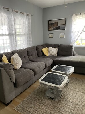 Relax in this inviting living area with a sofa, coffee table, and artwork on the walls.