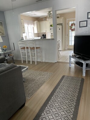 Relax in this stylish living space with a central island, flat-screen TV, and comfortable sofa.