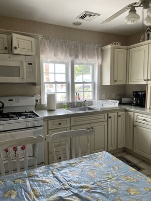Enjoy cooking in this well-equipped kitchen with a stove, microwave, and coffee maker.