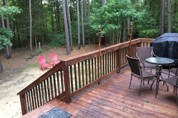 Back deck with grill. FirePit and Picnic Table are in yard.