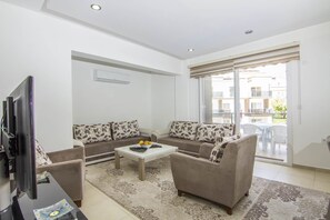 Apartment, 3 Bedrooms | Living area | Flat-screen TV