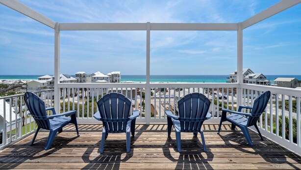 A wooden deck with three blue Adirondack chairs facing a beach. - Gulf views Beach House & Large Private Pool, 2 owner suites; Walk 2 Beach (Panama City Beach)
