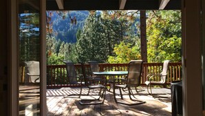An open door to a wooden deck with outdoor furniture and a view of a forested area. - Starview Lodge: Quiet Mountain Home Bordering State Forest (Cobb)