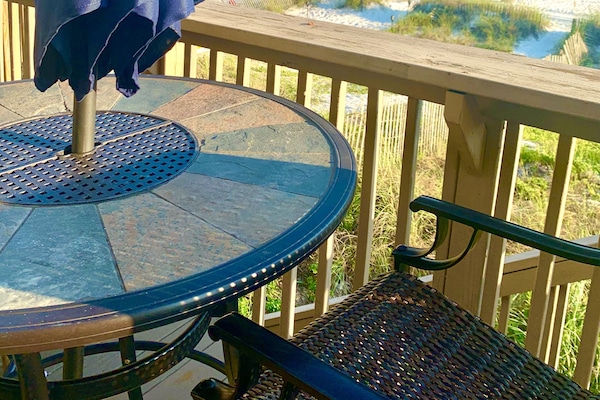 Back deck table w/ umbrella,Grill . 8 chairs &3 lounge chairs.