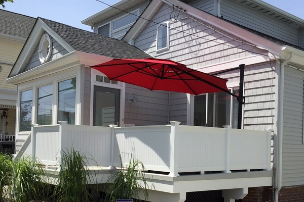Private porch with seating and adjustable umbrella