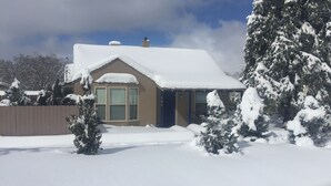 A house with a snow-covered roof and a fenced yard. - Abba House Downtown  (Prescott)