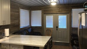 A kitchen with a marble countertop, wooden cabinets, a built-in bench, and a refrigerator. - Houseboat Located In Venice Marina (Venice)