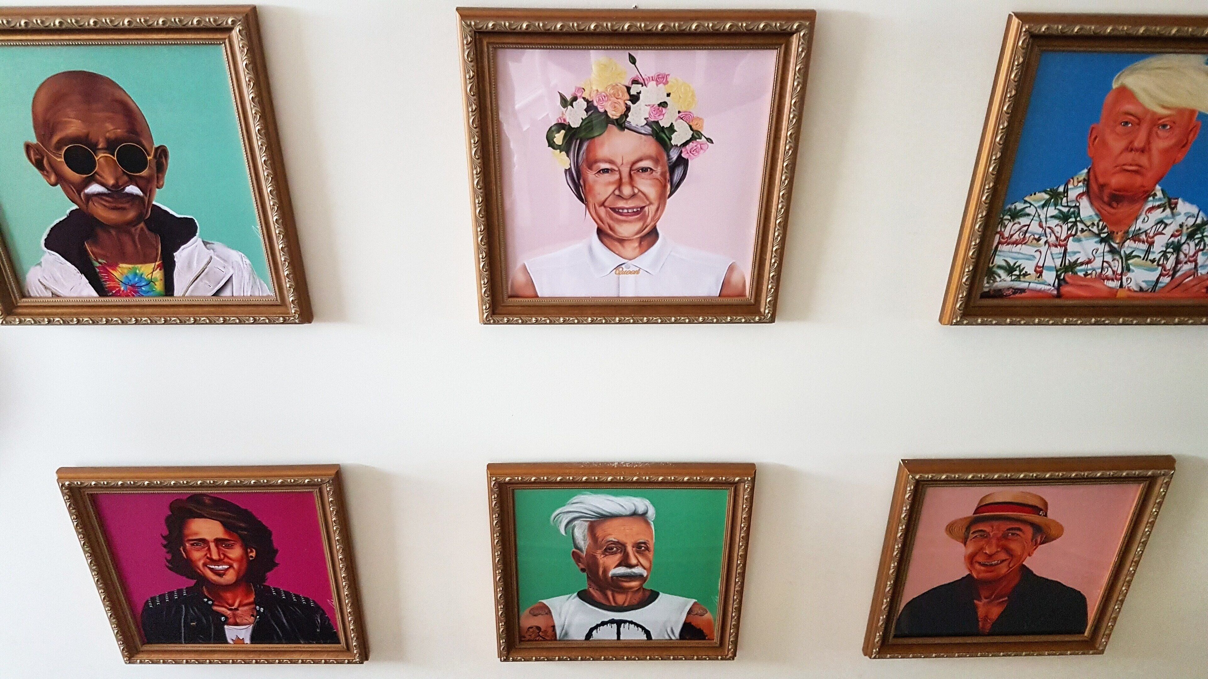 Six framed portraits on a wall.