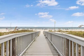 A wooden boardwalk leading to a beach with a clear sky. - Spanish Key 504, next to Flora-Bama, beachfront (Pensacola)