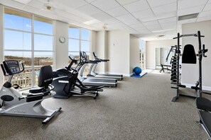 A gym with treadmills, a stationary bike, and weightlifting equipment.