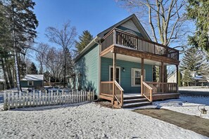A two-story house with a porch and a fenced yard. - Beautiful Lake house is waiting! (Lexington)