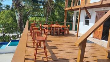 A wooden deck with outdoor seating and a pool.