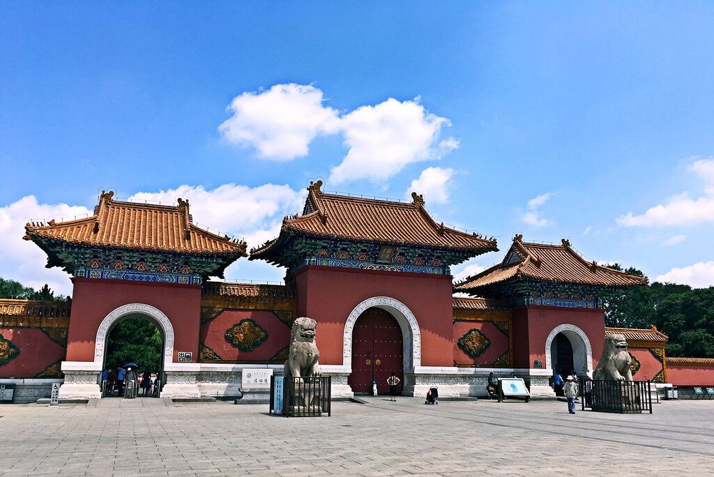 A traditional Chinese gate with ornate decorations and lion statues.