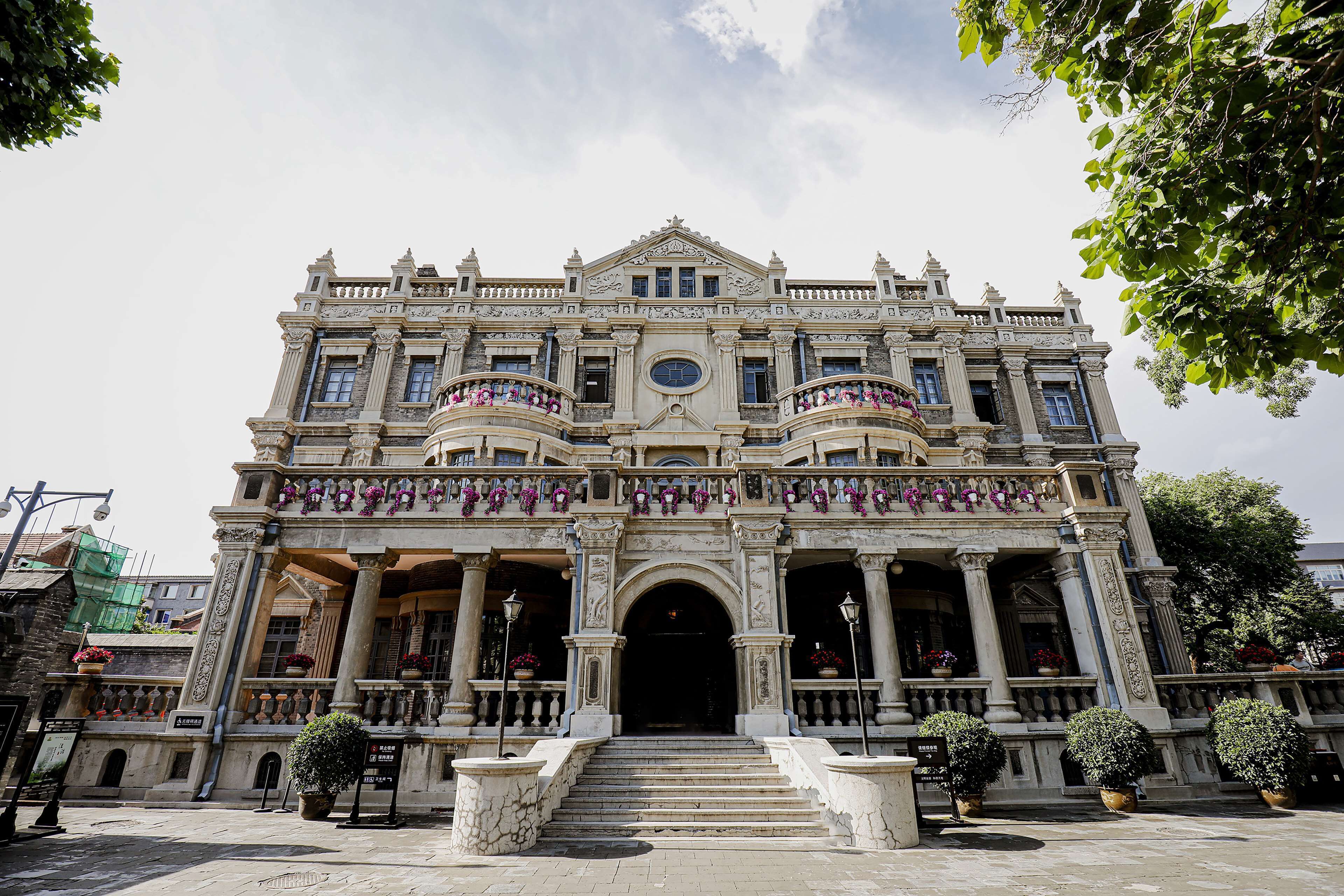 A grand historic building with ornate architecture, large columns, and a central entrance.