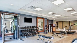 A gym with exercise equipment, dumbbells, treadmills, and a bench. - Homewood Suites by Hilton Poughkeepsie (Poughkeepsie)