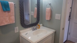 A bathroom with a white sink, a mirror, and two towels hanging on towel rings. - Gulf Shores Plantation ~ Resort Conference Center #1169  (Gulf Shores)