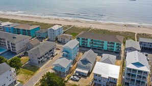 A coastal residential area with multi-story buildings, a beach, and a clear view of the ocean. - "Sand Dollar Suites" suite 4: A short stroll from our sandy shores! (Carolina Beach)