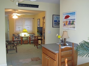 Relax in this cozy living space with a TV, dining area, and ceiling fan.