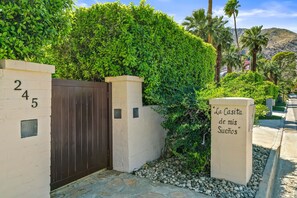A gated entrance with a sign reading 'La Casita de mis Sueños' and a house number '245'.