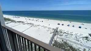 A beach with white sand, clear blue water, and a wooden boardwalk. - Seabatical at The Gulf Tower, Beautiful Beachfront Condo (Gulf Shores)