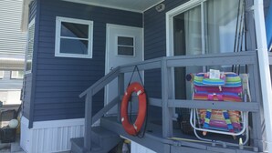 A house with a porch, a lifebuoy, and colorful beach chairs. - Relax by Florida Keys Beaches, just a 7-min drive away (Cudjoe Key)