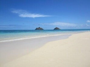 A beach with clear blue water and two small islands in the distance. - Footsteps to Hawaii's Best Beach  (Kailua)