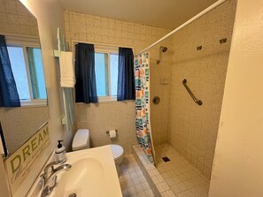 A bathroom with a shower, toilet, and sink. - Tropical Retreat! Just steps to the surf & sunsets! (San Diego)