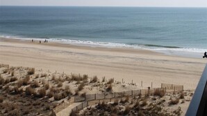 A beach with a sandy shore and sparse vegetation. - Ocean Front, North Ocean City, Maryland  (Ocean City)