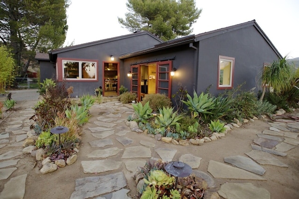 Flagstone path bordered by succulent and native grasses
