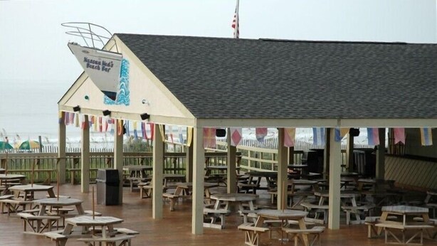 A beachside restaurant with outdoor seating and a covered area. - Weeks in September still available! Book now for a great vacation. (Myrtle Beach)